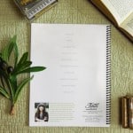 Sheet music back cover of "Where Faith Begins" sitting on a table with a model piano, bible, and plant.