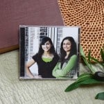 CD of "Stand Still". The music is surrounded by a bible and a small leafy plant.