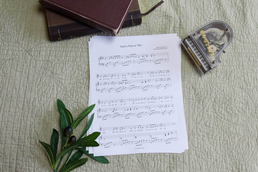 Sheet music to "For Such A Time As This". The music is surrounded by a model piano, a bible, and a small leafy plant.
