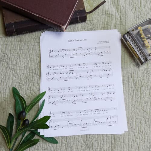 Sheet music to "For Such A Time As This". The music is surrounded by a model piano, a bible, and a small leafy plant.