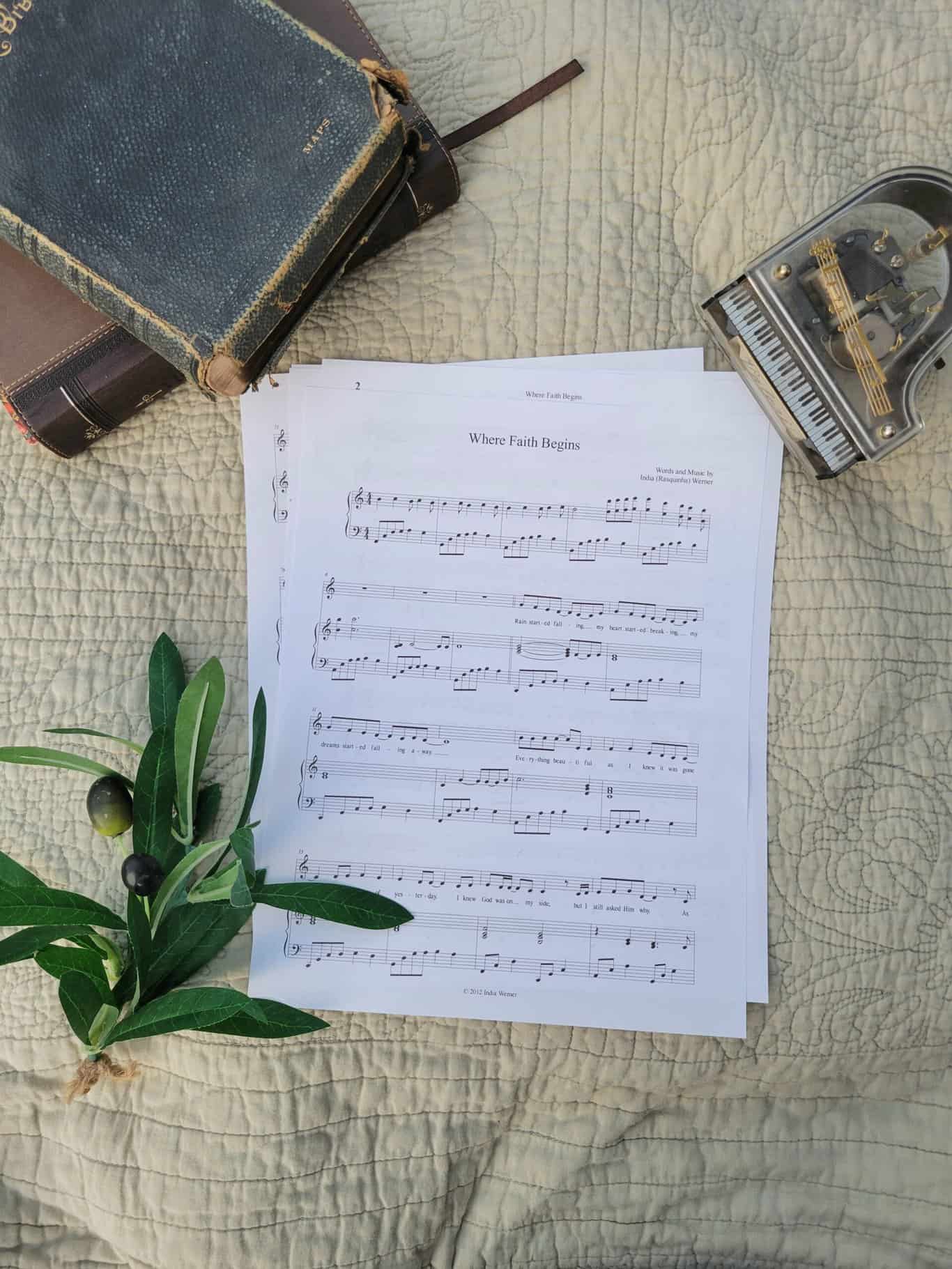 Sheet music to "For Such A Time As This". The music is surrounded by a model piano, a bible, and a small leafy plant.
