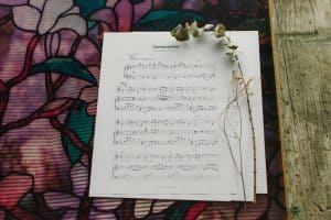 Sheet Music to "Consecration" laying on a table with flowers around it.