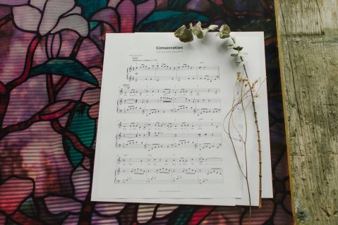 Sheet Music to "Consecration" laying on a table with flowers around it.